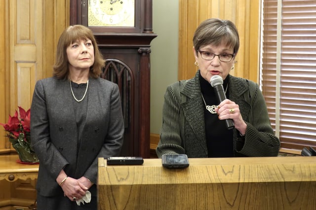 FILE - Shawnee County, Kansas District Judge Evelyn Wilson listens as Kansas Gov. Laura Kelly talks about Wilson's appointment to the Kansas Supreme Court during a news conference, Dec. 16, 2019, at the Statehouse in Topeka, Kansas. (AP Photo/John Hanna, File)