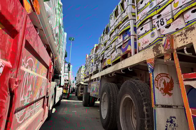 Trucks carrying humanitarian aid line up on the Egyptian side of the Rafah border crossing.