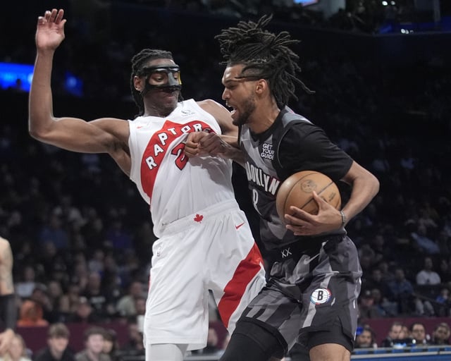 Apr 6, 2025; Brooklyn, New York, USA; Brooklyn Nets forward Ziaire Williams (8) drives the ball against Toronto Raptors forward Jonathan Mogbo (2) during the second half at Barclays Center. Mandatory Credit: Gregory Fisher-Imagn Images