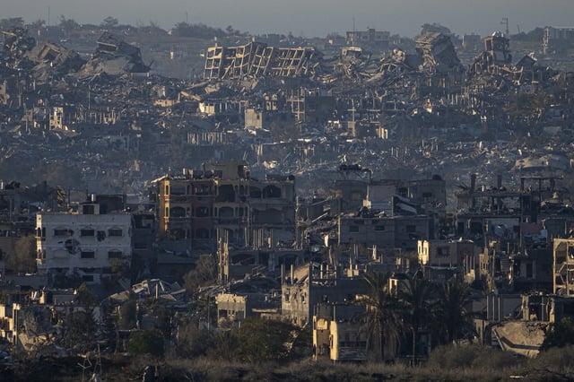 FILE - Destroyed buildings are seen inside the Gaza Strip from southern Israel, Jan. 13, 2025. (AP Photo/Ariel Schalit, File)