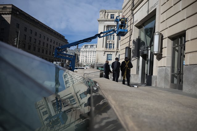 A worker removes the US Agency for International Development (USAID) name from its headquarters in Washington, DC, on February 7. USAID was a major initial target of DOGE.