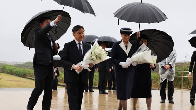 Emperor Naruhito and Empress Masako carry flowers to lay at war veterans’ monuments at Iwo Jima
