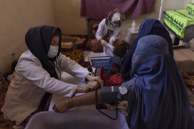 A midwife assesses a pregnant woman at a mobile health clinic in Kabul, Afghanistan.