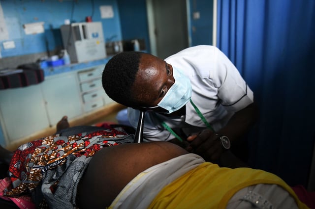 A midwife listens to an unborn baby's heartbeat at a health center in Chiradzulu, Malawi.