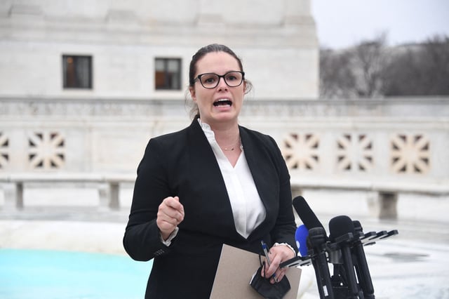Allison Riggs speaks to the press in front of the US Supreme Court in Washington, DC, on December 7, 2022.