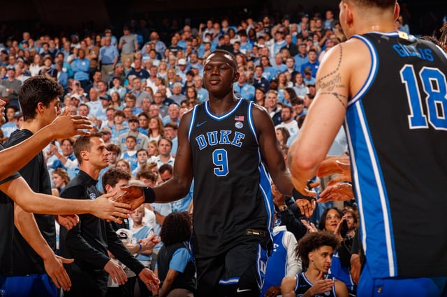 Khaman Maluach #9 of the Duke Blue Devils high fives teammates during introductions before a game against the North Carolina Tar Heels at the Dean Smith Center on March 08, 2025 in Chapel Hill, North Carolina. 