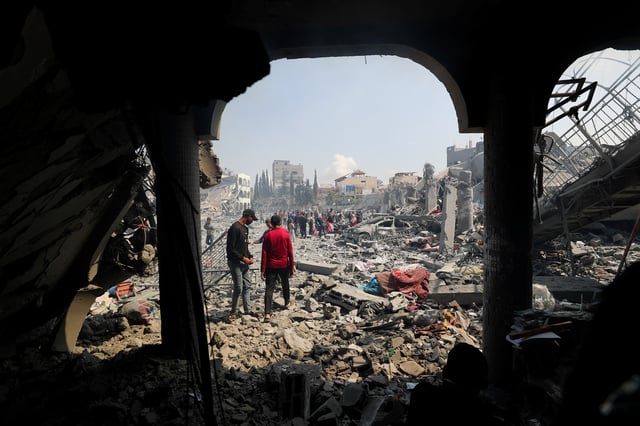 Palestinians inspect the damage at the Dar Al-Arqam school, where displaced people shelter, after it was hit by an Israeli strike on Thursday, in Gaza City, April 4, 2025. REUTERS/Mahmoud Issa/File Photo