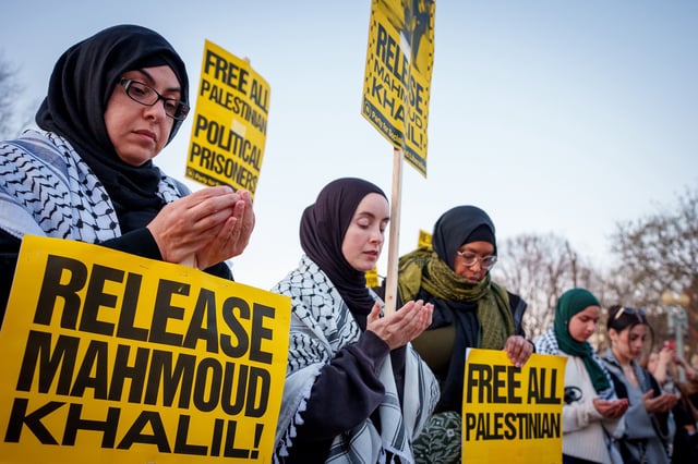 Muslim women of all colors, wome in hijab and some not, make Dua for Mahmoud Khalil during an outdoor demonstration
