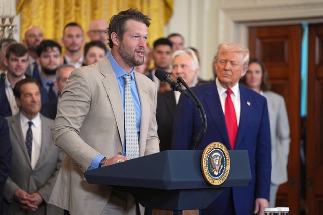 President Donald Trump listens as Dodgers pitcher Clayton Kershaw speaks during a ceremony to honor the Major League Baseball 2024 World Series Champion team in the East Room of the White House, Monday, April 7, 2025, in Washington. (AP Photo/Evan Vucci)