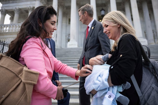 Rep. Anna Paulina Luna greets Rep. Brittany Pettersen and her infant son, Sam, outside the Capitol on March 31, 2025.