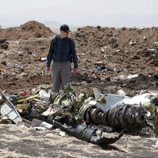 FILE PHOTO: American civil aviation and Boeing investigators search through the debris at the scene of the Ethiopian Airlines Flight ET 302 plane crash, near the town of Bishoftu, southeast of Addis Ababa, Ethiopia March 12, 2019. REUTERS/Baz Ratner/File Photo