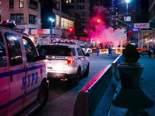 Colorful New York City at night with police and the Big Apple's typical smoke cloud.