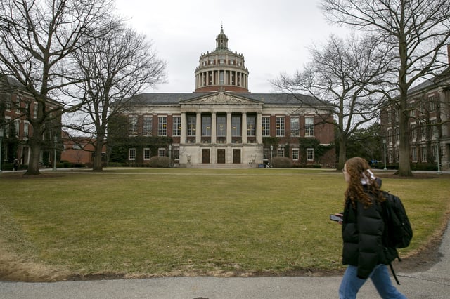 FILE - A student walks by the Rush Rhees Library at the University of Rochester, Feb. 22, 2023. (AP Photo/Ted Shaffrey, File)