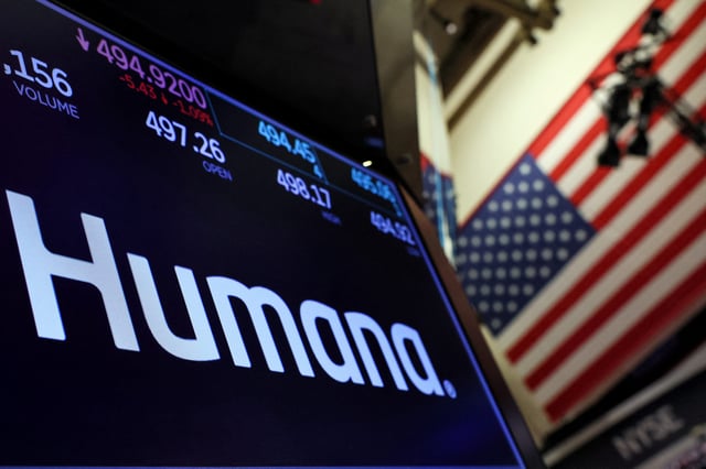 A screen displays the logo and trading information for Humana on the floor at the New York Stock Exchange (NYSE) in New York City.