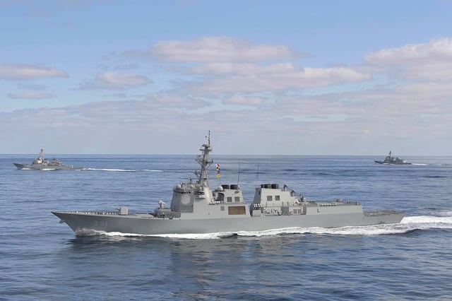 South Korean Aegis destroyer King Sejong the Great, front, sails with the USS Barry, left, and Japan's destroyer Atago, during joint exercises on February 22, 2023.