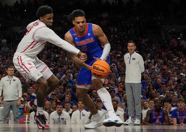 Houston Cougars guard Mylik Wilson (8) battles with Florida Gators guard Will Richard (5) for the ball during the first half of the NCAA men&#39;s college basketball championship game in San Antonio, Monday, April 7, 2025.