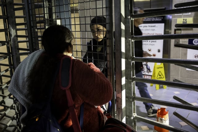 An immigrant tries in vain to cross into the United States for a cancelled appointment with immigration officials a day after the second inauguration of U.S. President Donald Trump on January 21, 2025 in Nogales, Mexico.