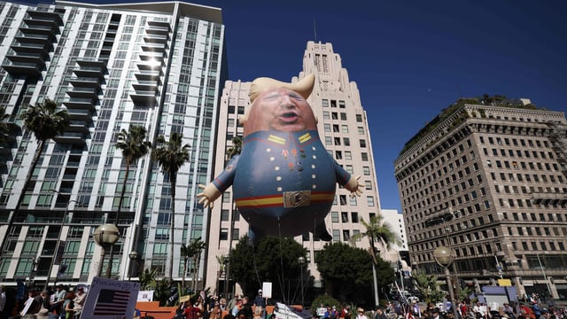 Protesters hold a large balloon with an image of US President Donald Trump during the nationwide Hands Off! protest against Trump and his advisor, Tesla CEO Elon Musk, in downtown Los Angeles on April 5, 2025. 