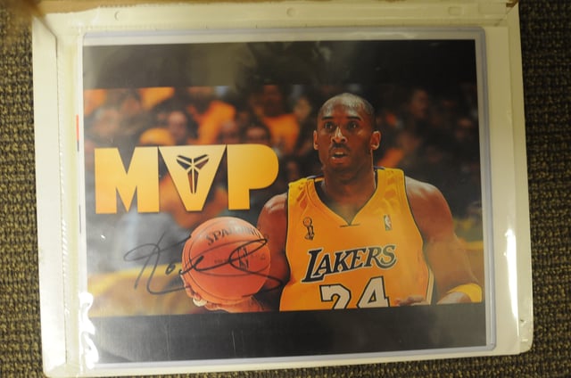 A photograph of Kobe Bryant provided by the U.S. Attorney's Office featuring the forged signature of the basketball icon.