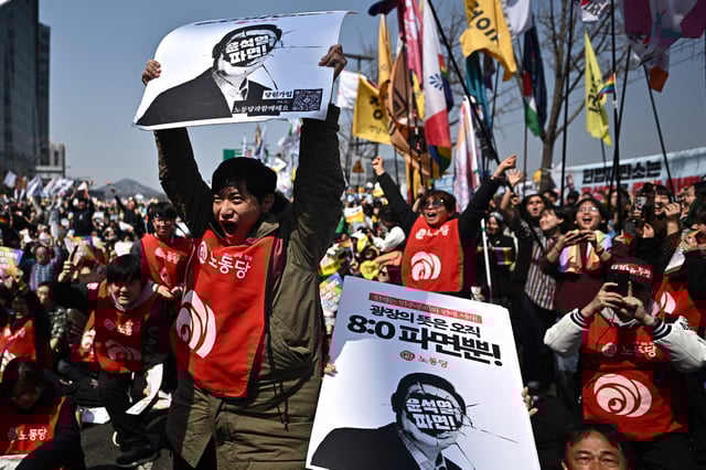 Anti-Yoon protesters react after the Constitutional Court's verdict on the impeachment of South Korea president Yoon Suk Yeol in Seoul on April 4, 2025.