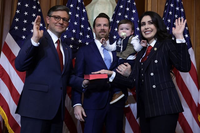Speaker of the House Mike Johnson, left, participates in a ceremonial swearing-in with Rep. Anna Paulina Luna, right, and her family at the US Capitol on January 3, 2025.