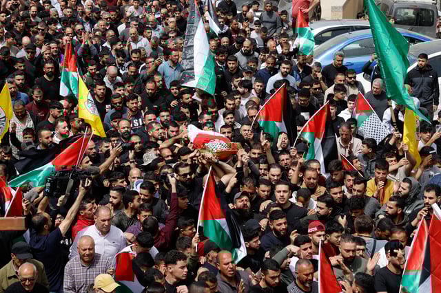 Mourners carry the body of Palestinian-American boy Omar Mohammad Rabea, 14, who was killed by Israeli forces in Turmus Ayya village, during his funeral, near Ramallah in the Israeli-occupied West Bank April 7, 2025. REUTERS/Ammar Awad/File photo