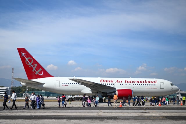 Guatemalan migrants deported from the United States walk on the tarmac after landing at the Air Force Base in Guatemala City in the first flight of deportees of the year on January 3, 2024. The US deported 55,000 Guatemalans between January and December 2023, a record that exceeds that of 2019, of 54,500, according to records of the General Directorate of Migration of Guatemala. (Photo by JOHAN ORDONEZ/AFP via Getty Images)