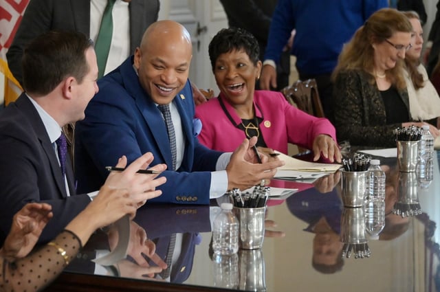 Maryland Senate President Bill Ferguson, Governor Wes Moore and House Speaker Adrienne Jones share a laugh while signing bills in the Governor’s Reception Room. (Kim Hairston/Staff)