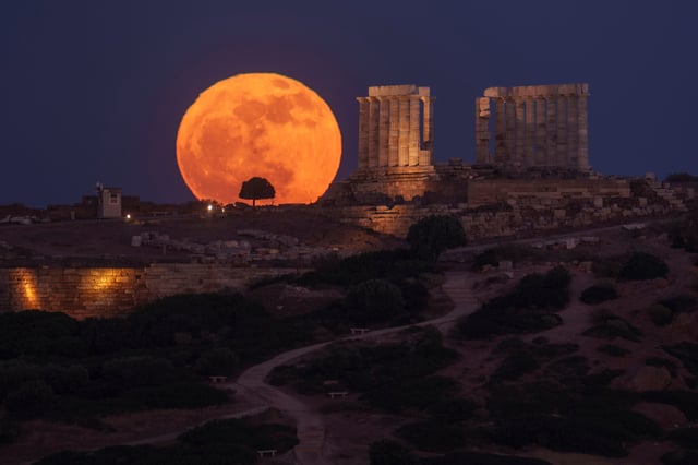FILE - The flower moon rises behind the ancient temple of Poseidon at Cape Sounion, about 70 kilometers (45 miles) south of Athens, Greece, on Thursday, May 23, 2024. (AP Photo/Petros Giannakouris, File)