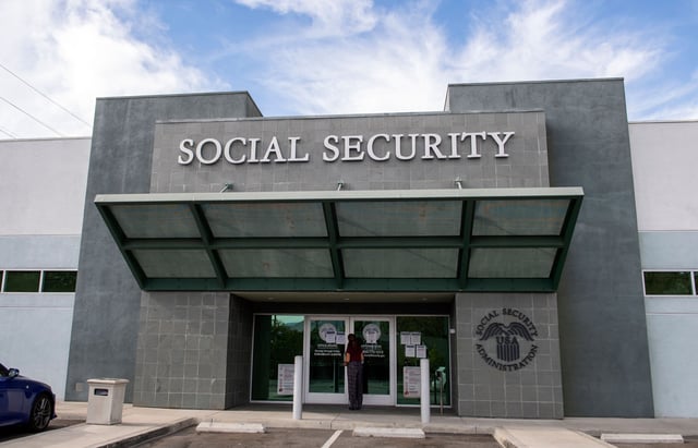 A woman stands outside a US Social Security Administration building, November 5, 2020, in Burbank, California.