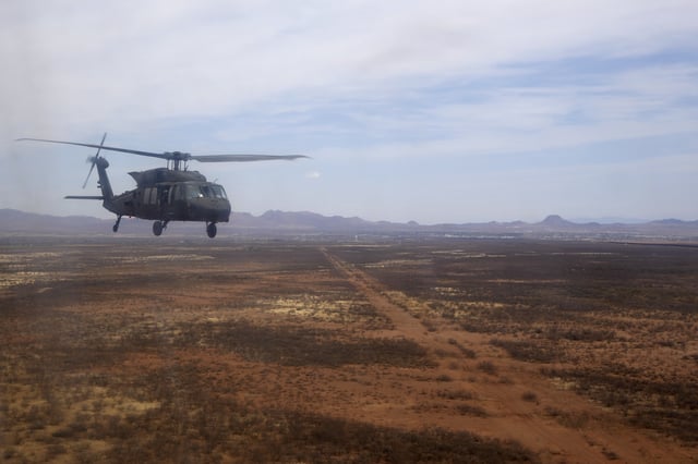 A U.S. Army Blackhawk helicopter transports members of the Joint Task Force Southern Border during a tour of the US-Mexico border , in Douglas, Ariz., Thursday, April 3, 2025. (AP Photo/Ross D. Franklin)