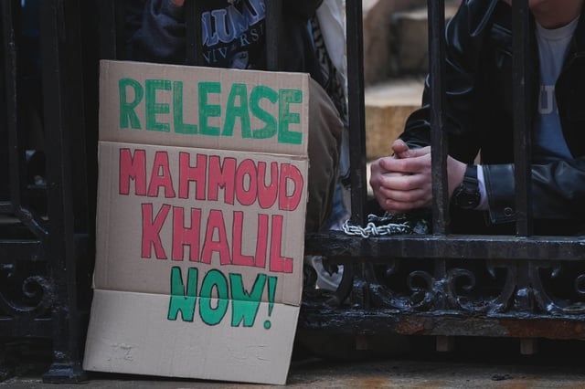 A sign reading "Release Mahmoud Khalil Now" is seen as Jewish students chain themselves to the gates of Columbia University, demanding accountability from the university's trustees following the arrest of Mahmoud Khalil, in New York, United States on April 2, 2025.