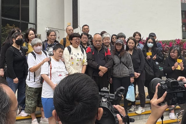 Hong Kong social worker Jackie Chen, second left in bottom row, pose for a photo with her supporters outside the District Court building in Wan Chai, Hong Kong ahead of her verdict hearing Tuesday, March 11, 2025. (AP Photo/Kanis Leung)