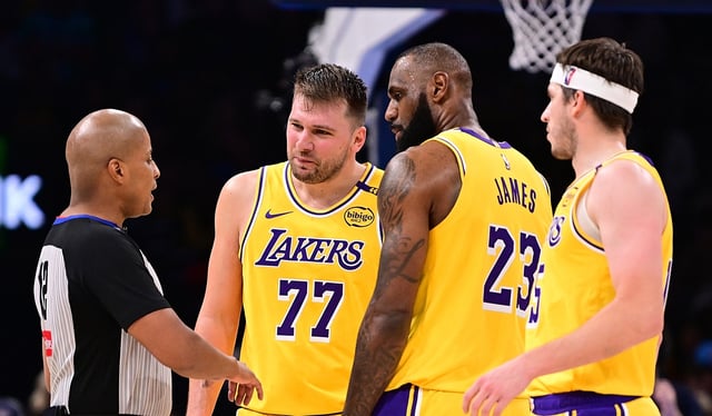 Lakers stars Luka Doncic (77) and LeBron James (23) speak to an official during the second half of their game against the Oklahoma City Thunder as teammate Austin Reaves, far right, looks on Tuesday night in Oklahoma City. Doncic was ejected after receiving a second technical foul. (Photo by Joshua Gateley/Getty Images)