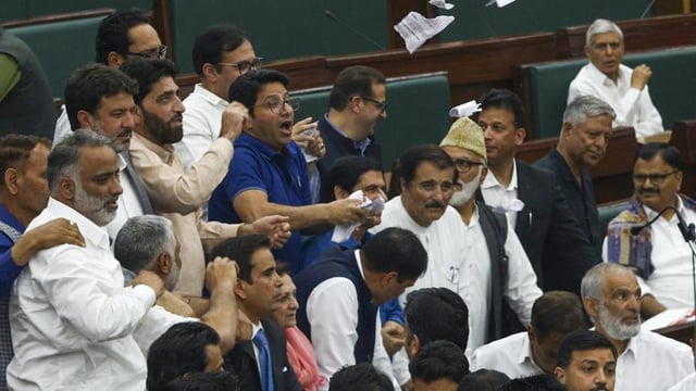 MLAs raise slogans inside the House during the Budget session of J&K Assembly, in Jammu, Tuesday. (PTI)