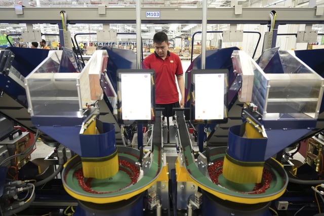 A worker operates packing machines at Lego factory in Binh Duong, Vietnam Wednesday, April 2, 2025. (AP Photo/Hau Dinh)