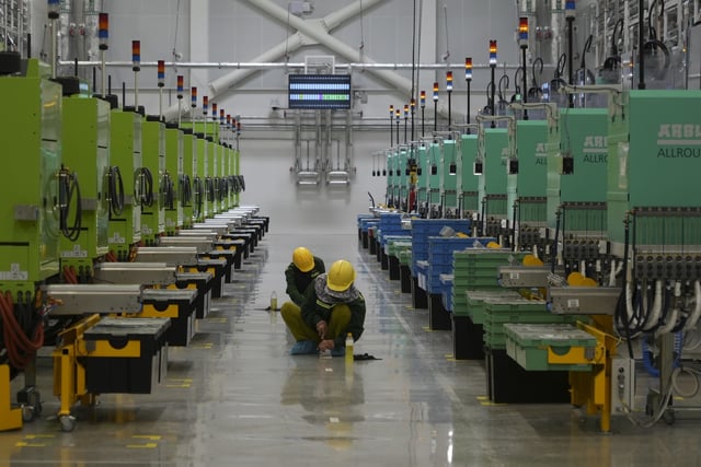 Workers scrub the floor at Lego factory in Binh Duong, Vietnam Wednesday, April 2, 2025. (AP Photo/Hau Dinh)