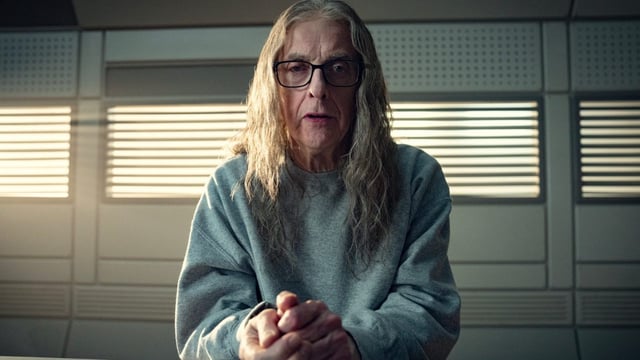 Peter Capaldi sitting in the interrogation room in Black Mirror episode Plaything.