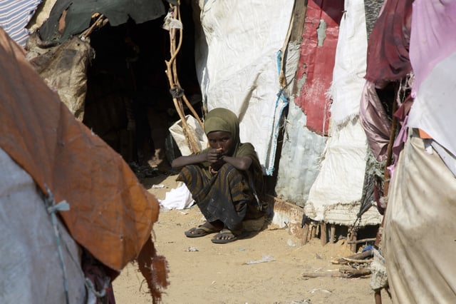A Somali internally-displaced (IDP) child sits outside makeshift homes in Maslah camp, on the outskirts of Mogadishu, Somalia, Wednesday, April 9, 2025. (AP Photo/Farah Abdi Warsameh)