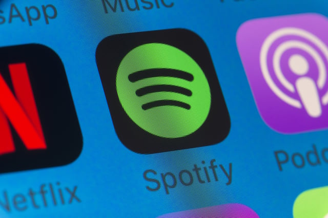 Stock image shows Spotify, Netflix and Apple Podcasts apps on the screen of an iPhone.