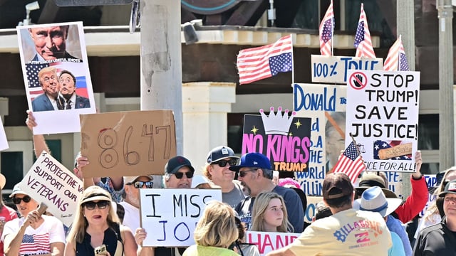 Trump's approval ratings declined as protestors held signs during a Hands Off! protest against the policies of the US President and his advisor, Tesla CEO Elon Musk, in Huntington Beach, California, on April 5, 2025. (Photo by Frederic J. Brown / AFP)