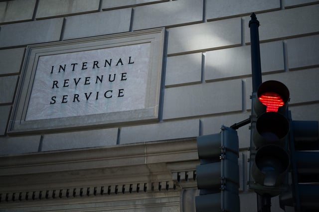 The exterior of the IRS building with a red stop light
