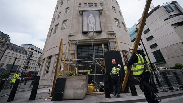 A protective screen has been put around the controversial sculpture outside Broadcasting House