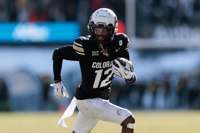Travis Hunter #12 of the Colorado Buffaloes runs with the ball during the third quarter against the Oklahoma State Cowboys at Folsom Field.