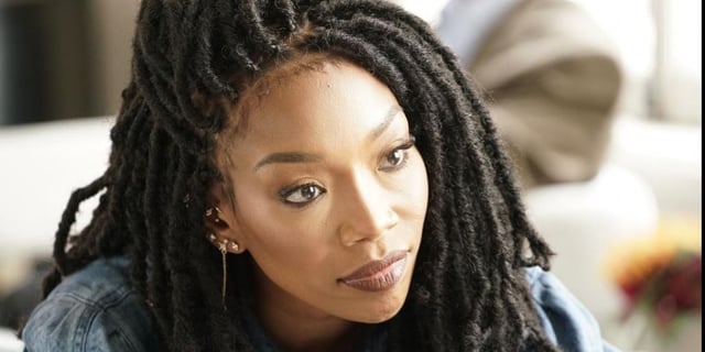 Brandy Norwood looks serious and stares off camera in Queens.