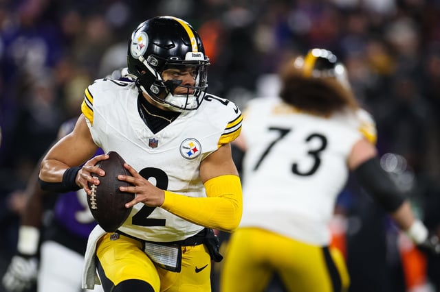 Justin Fields #2 of the Pittsburgh Steelers carries the ball against the Baltimore Ravens during the first half of the AFC Wild Card Playoff game.