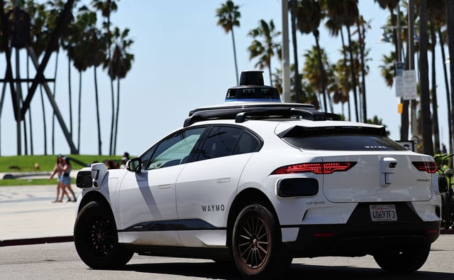 An autonomous Waymo drives along Venice Beach on March 14, 2024, in Los Angeles. The robotaxi company is expanding to cities across the country.