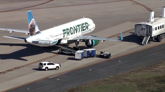 A Frontier plane sits on the ground at Washington Dulles International airport in Virginia after a beeping noise was heard from the cargo hold Wednesday, April 9, 2025.