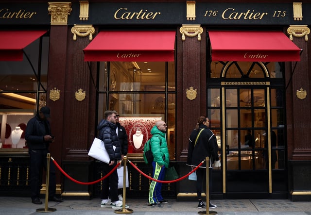 People queue outside a Cartier store on New Bond Street in London, Britain, March 11, 2023. REUTERS/Henry Nicholls