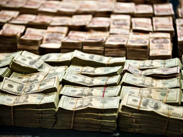 Pparcial view of more than 1 Million Dollars and more than 41 Million Mexican pesos seized to the alleged member of Zetas drug cartel Eric Jovan Lozano Diaz (out frame) aka "Cucho", presented to the press  in Mexico City, on June 15, 2012. Lozano was arrested in Nuevo Laredo, Tamaulipas State. AFP PHOTO/RONALDO SCHEMIDT        (Photo credit should read Ronaldo Schemidt/AFP/GettyImages)